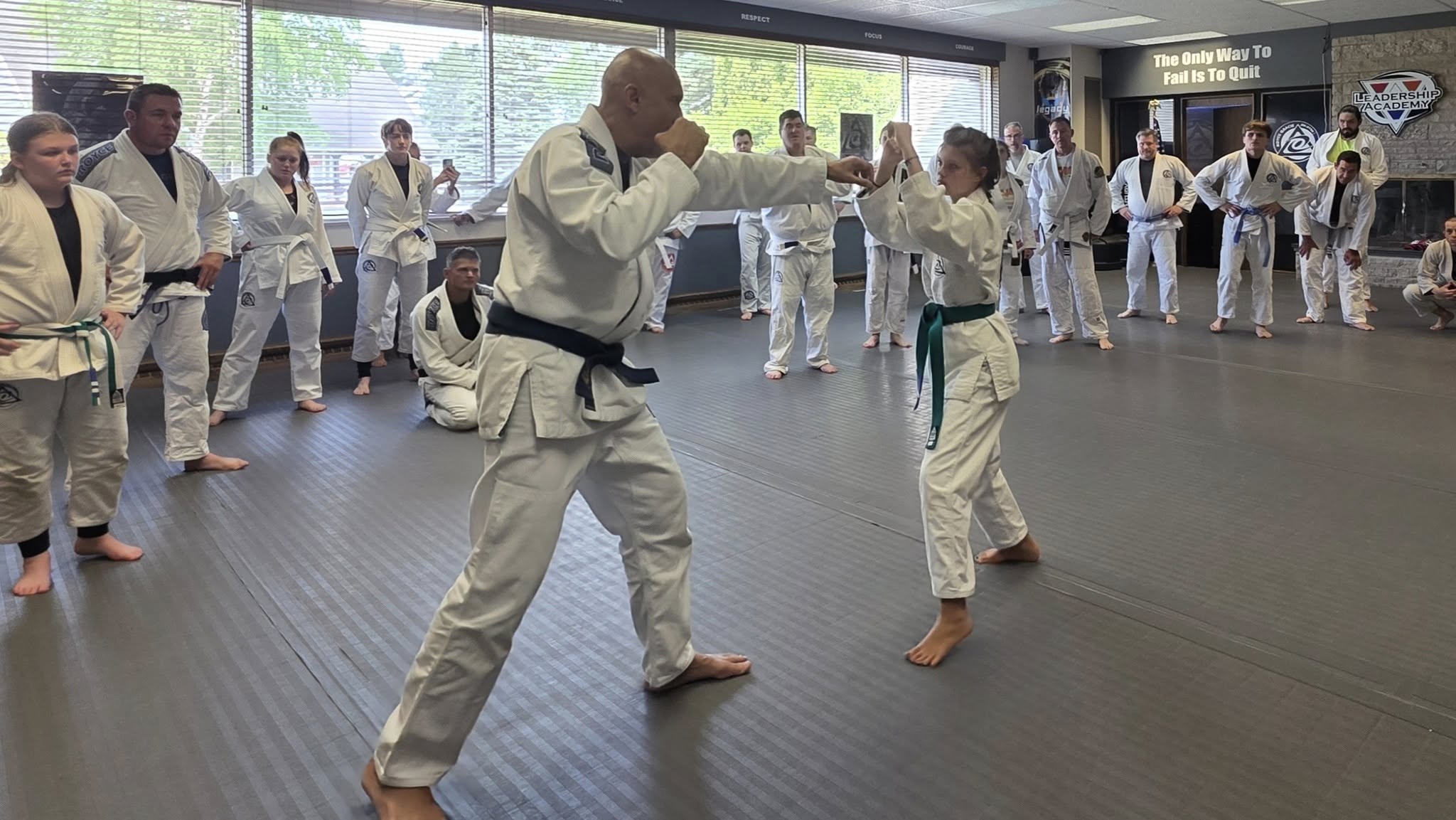 Royce Gracie demonstrating self-defense with a youth student